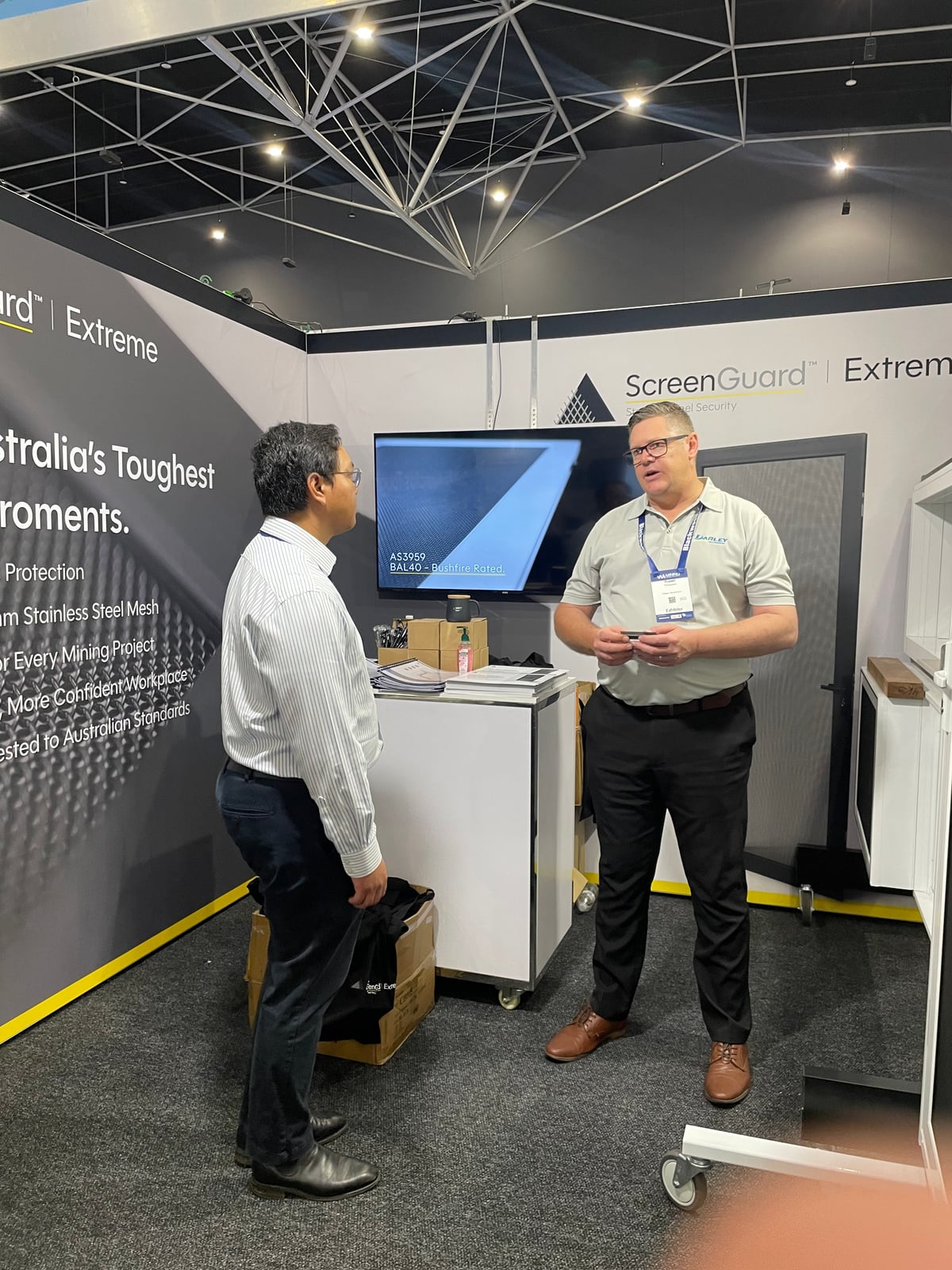 Prashanth Danam and the WA Team speaking with a visitor on the stand